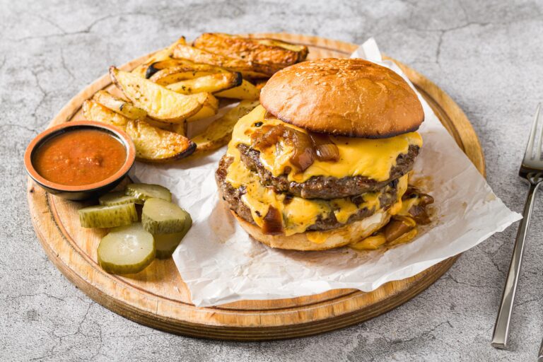 Smash,Burger,With,Cheddar,Cheese,And,Caramelized,Onions,,Served,With